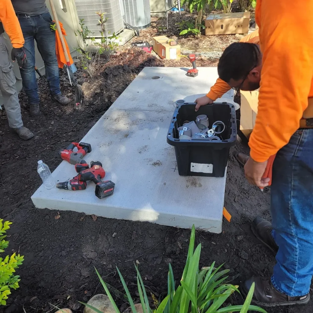 Technicians preparing a concrete pad for a generator installation