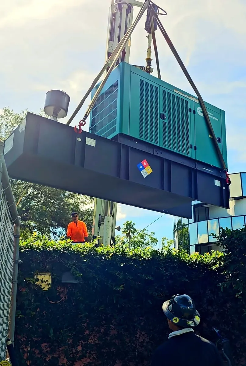 Generator lifted by crane during an equipment replacement project