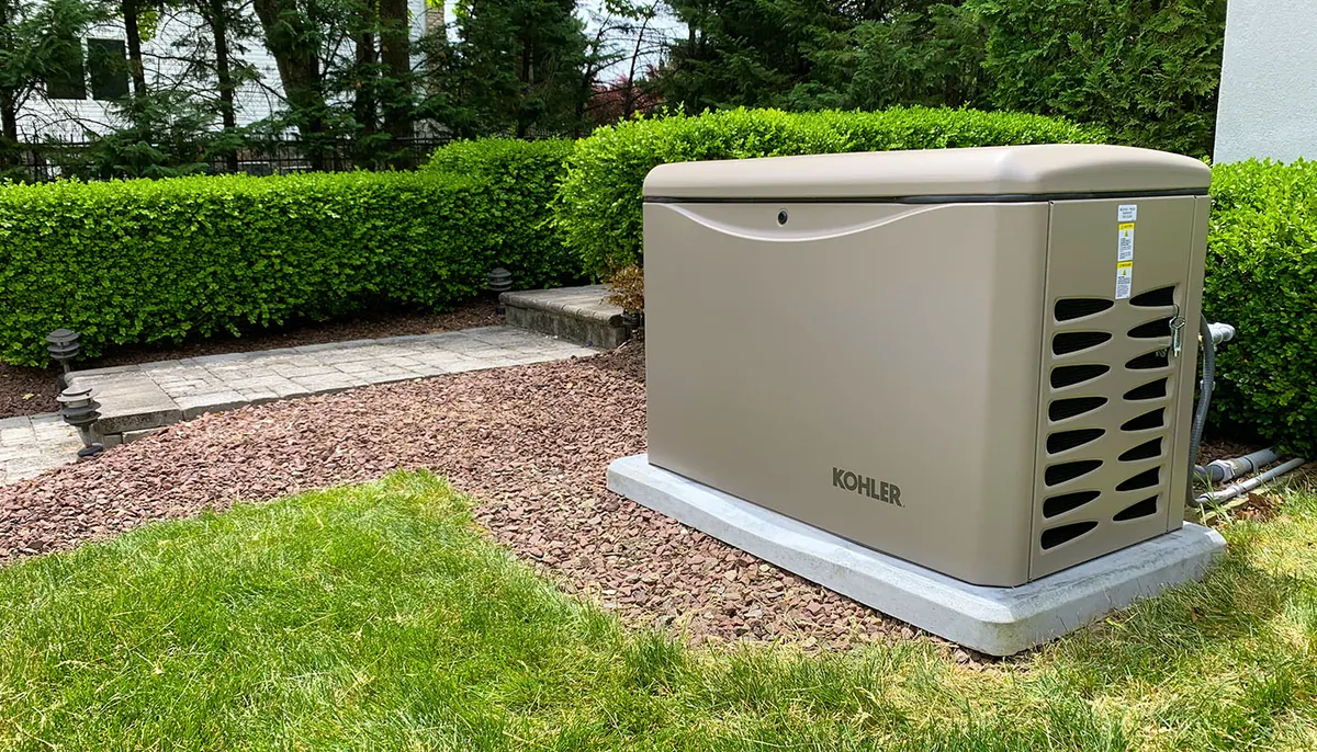 Kohler home standby generator installed on a gravel pad